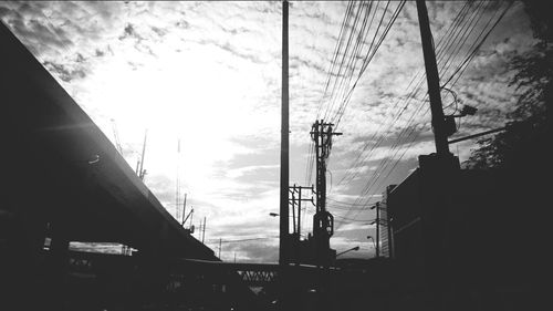 Silhouette of building against cloudy sky