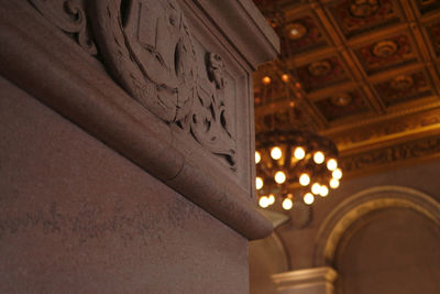 Low angle view of illuminated chandelier at night