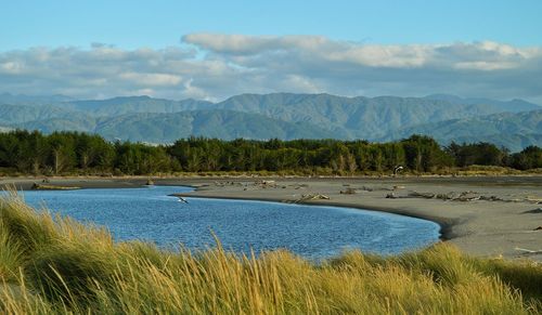 Scenic view of mountains against cloudy sky