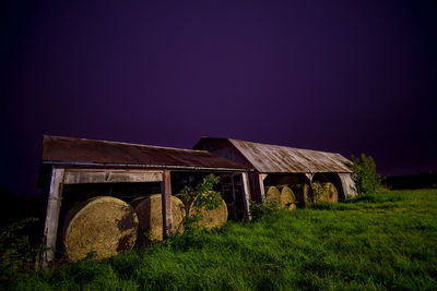 Built structure on field against clear sky at night