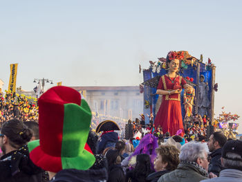 Group of people in temple against sky in city