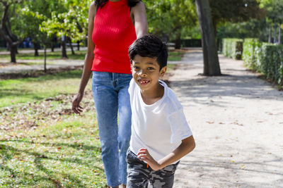 Happy mother and son enjoying together outdoors in a park.