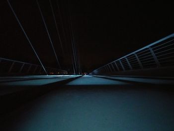 Illuminated bridge against sky at night