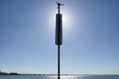 Low angle view of pole against clear blue sky