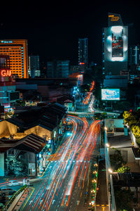 High angle view of illuminated city street and buildings at night