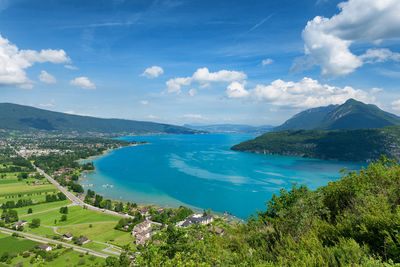 Scenic view of sea and mountains against sky