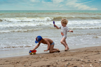 Full length of boy running on beach