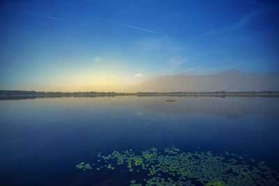 Scenic view of lake against blue sky