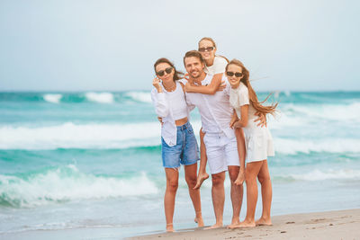 Friends standing at beach