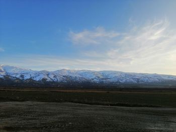 Scenic view of snowcapped mountains against sky