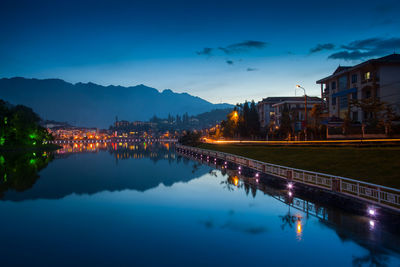 Reflection of illuminated buildings in lake at night