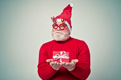 Portrait of man against red background