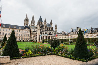 View of garden with buildings against sky