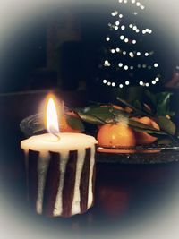 Close-up of lit candles on table