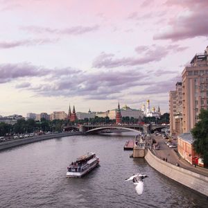 Boats in river with buildings in background