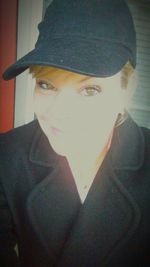 Close-up portrait of young woman at home