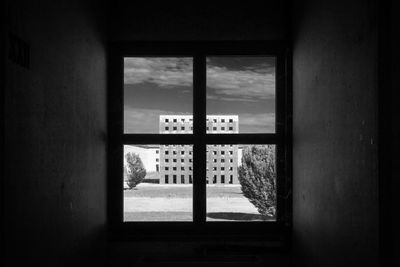 Buildings seen through closed window of building