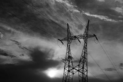 Low angle view of electricity pylon against sky