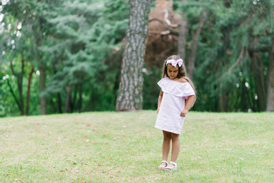 A little child girl walks in the park in the summer. summer holidays in nature person