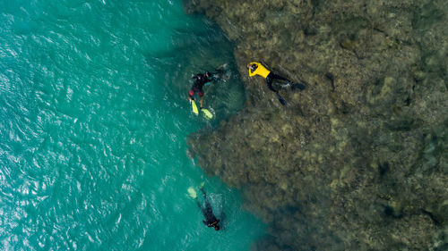 High angle view of people swimming in sea