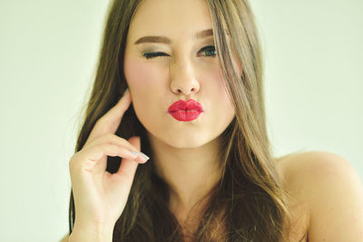 Portrait of beautiful woman against white background