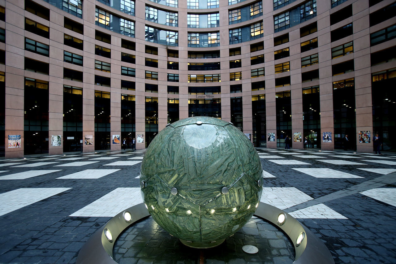 SCULPTURE ON STREET AGAINST BUILDINGS