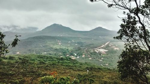 Scenic view of mountains against cloudy sky