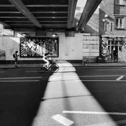 People riding bicycle on road