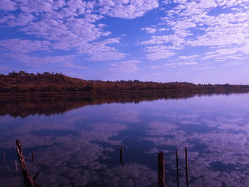 Scenic view of lake against cloudy sky