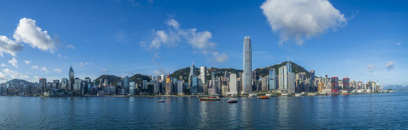 Panoramic view of buildings by sea against sky