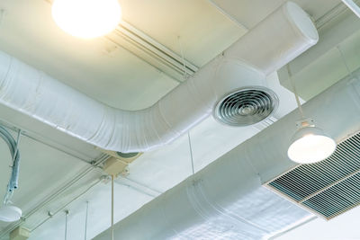 Low angle view of illuminated lights hanging from ceiling