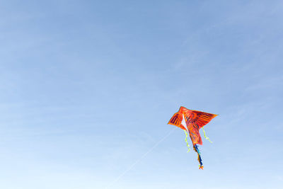 Low angle view of kite flying against sky