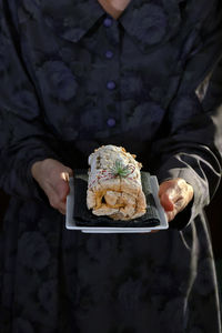 Midsection of man holding ice cream cone