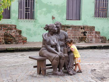 Statue of man sitting on bench