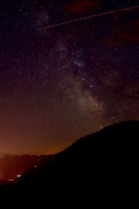 Scenic view of silhouette mountain against sky at night