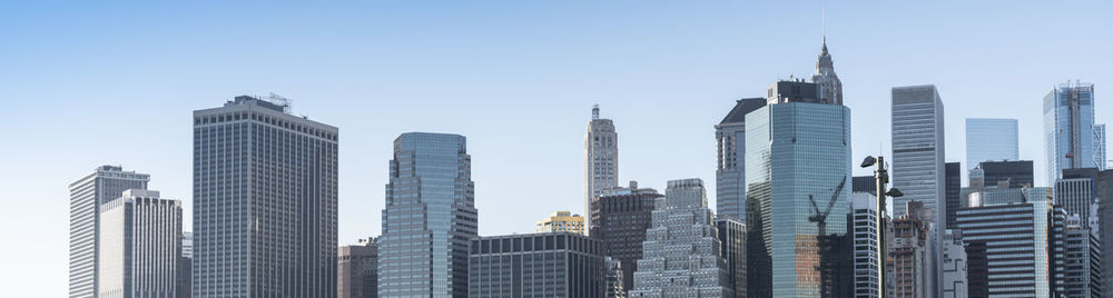 Low angle view of buildings in city against clear sky