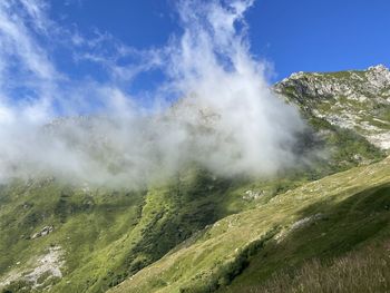 Scenic view of waterfall against sky