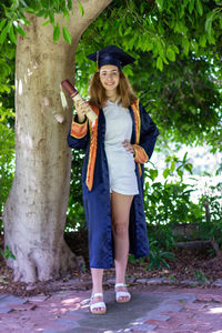 High school graduate. schoolgirl in graduation cap and mantle.