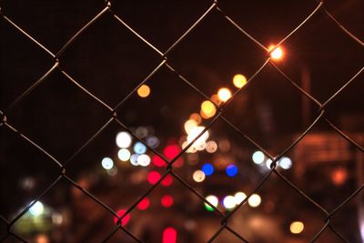 Full frame shot of illuminated chainlink fence at night