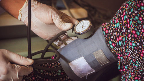 Cropped image of doctor checking blood pressure