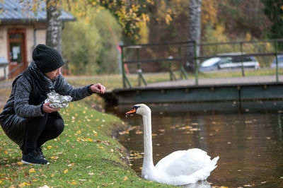 Side view of man with dog in lake