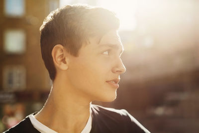 Thoughtful teenage boy looking away outdoors