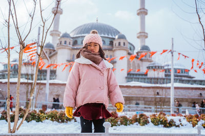 Portrait of woman standing in city