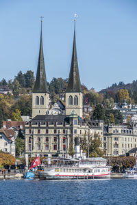 View of building by river against sky