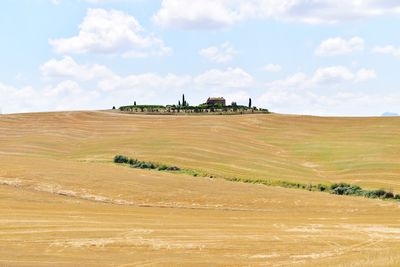 Scenic view of farm against sky