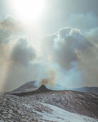 Scenic view of volcanic mountain against sky