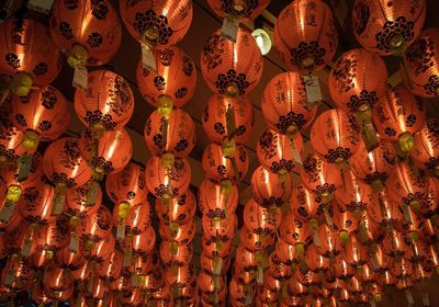 Low angle view of illuminated lanterns hanging on ceiling