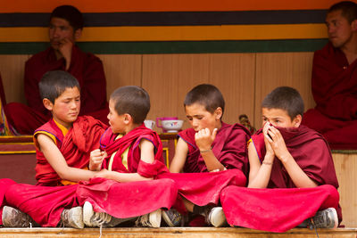 Group of people sitting on floor