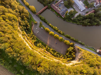 High angle view of road amidst trees and buildings