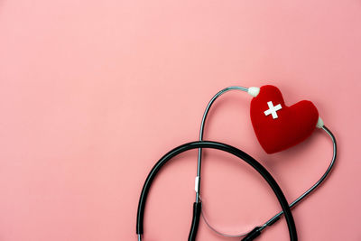 Close-up of heart shape against pink background